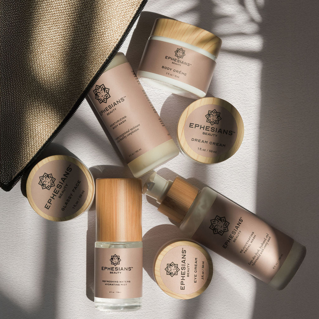 Ethereal skincare products with a black bag on a textured surface