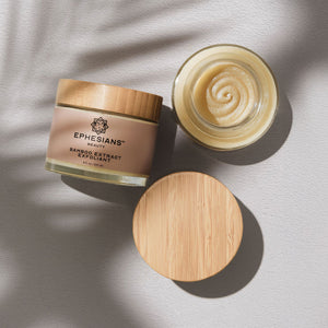 Two jars of a product with wooden lids on a light background