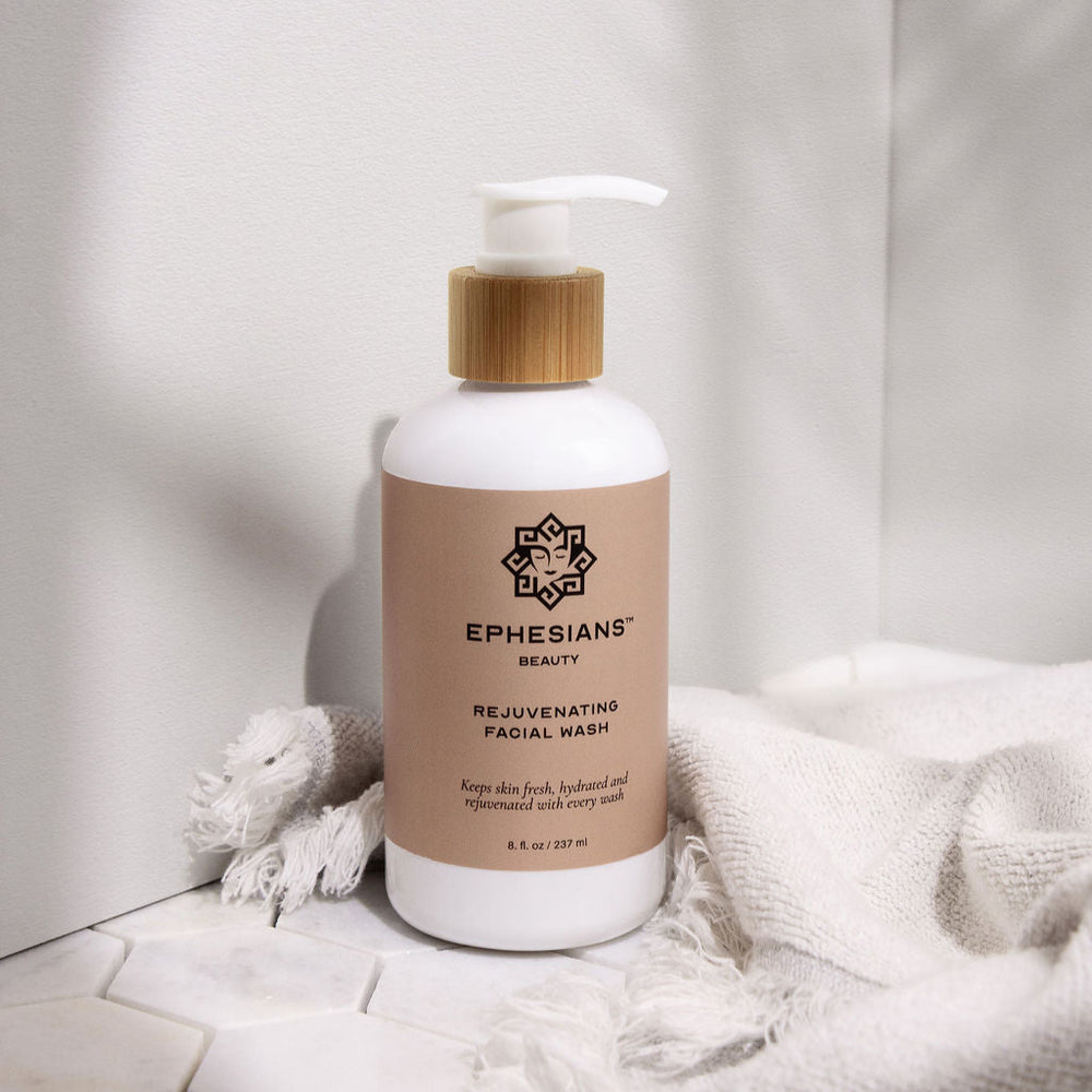 Bottle of Ephesians Beauty product on a white surface with a neutral background